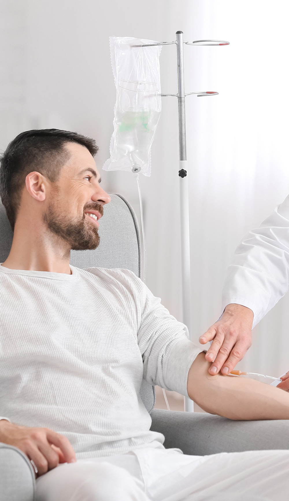 Doctor and man undergoing course of IV Drip treatments