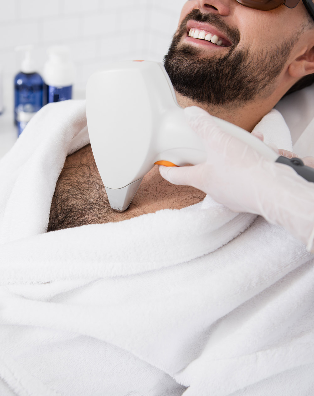 Close up of hand with laser hair removal on hairy male chest